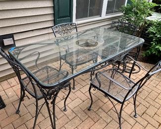 Wrought iron patio furniture  Patio table w/glass top and 4 chairs $240.