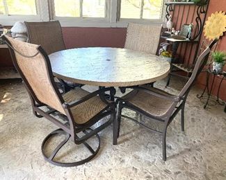Like new - faux stone heavy aluminum patio table and 4 chairs
