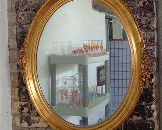 L36  Modern oval gilded mirror (29"W x 35"H)  $49.