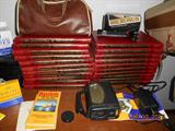 Photography reference books, assorted 35 mm camera lenses, camera bags, brand new tripod.