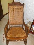 Carved caned rocker
