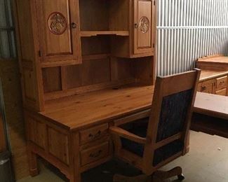 Contemporary Rustic style furniture with US Marine insignia. Includes sectional desk with hutch. Hutch has shelves in both cabinets and desk has a pullout for keyboard. Also available is the desk chair, 4 matching bookshelves, 2 drawer file cabinet and credenza. Definitely a nice conversation piece for just the right office.