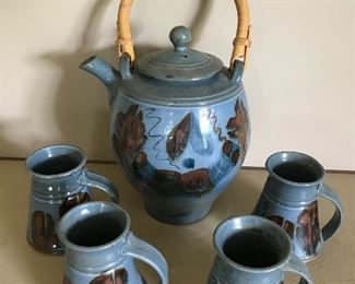 Pottery teapot and 4 mugs. Small chip to rim. $30 (orig. $40)
