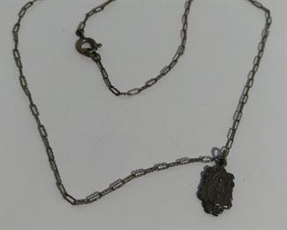 Lot #301 old medal on chain, $12