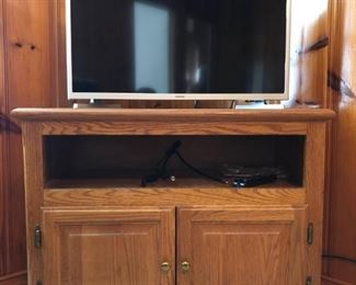 Samsung T.V. and wooden cabinet https://ctbids.com/#!/description/share/410262