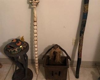 walking sticks, carved trash can, carved person table