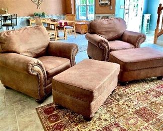 2 nail head arm chairs with matching ottomans