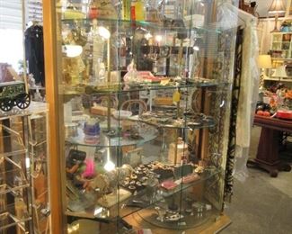 Costume jewelry many unique small items.  Note the case is for sale also it has double turning shelves on each side great way to display your collectables