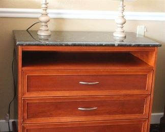 Granite top entertainment console, lamps	
SLH. Granite has two holes drilled in middle on top. Some scuffs and scratches on left bottom. Wood lamps with shades.