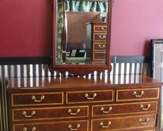 Thomasville Mahogany Collection dresser w/mirror	
Matches side table in lot 61. 9 drawers. Mirror attaches to dresser. In very good condition. Rolls on casters - on caster is missing.