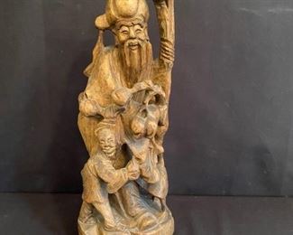 Asian Item 1	
Wooden statue 20" tall on 14 1/2" w x 10" d x 19 1/2" h marble topped stand, marble is cracked at one corner;
