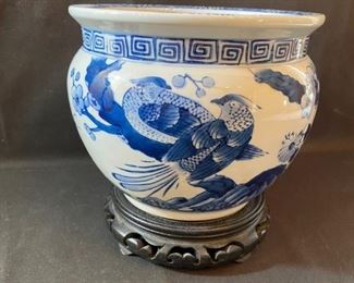 Asian Item 25	
White ceramic w/ blue decorative planter 6 1/2" h on wooden pedestal; Note: see photos
