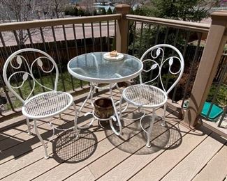 Patio set	
Table for 2: 2- white metal chairs, 1 metal frame table with glass top 27" dia;