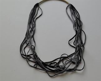 Leather tong necklace, upside down, w/ metal Demi circle. $24.00.