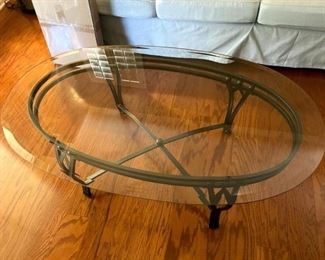 Glass oval coffee table with wrought iron base                        Measures 4ft x 28inches                                                                            PRICE: $45