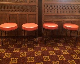4 Vintage Ottoman/Stools.  Faux orange leather and wrought iron. Priced separately.