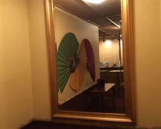 Large gold tone beveled mirror. 68 in x 44 in