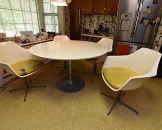 Item 4: White Kitchen Table & Chairs: $375 Unmarked tulip-style 48" table (presumed to be Burke). Has four chairs, marked Burke, Inc. Yellow vinyl seat cushions are in fair condition. Two have repairs made with duct tape (what else?). White (formica?) table top is worn.