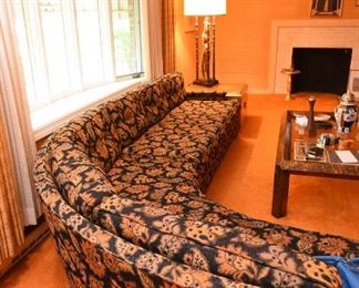 Item 5: Black floral curved sofa: $325 Anthony C. Sabbia Interior Design, Newton. Upholstery is in excellent condition, Black field with orange, brown, bronze, tan flowers.