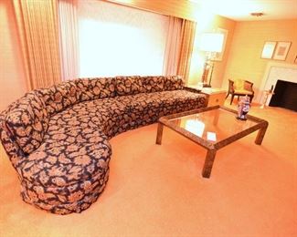 Item 5: Black floral curved sofa: $325 Anthony C. Sabbia Interior Design, Newton. Upholstery is in excellent condition, Black field with orange, brown, bronze, tan flowers.