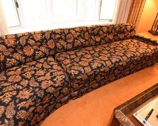 Item 5: Black floral curved sofa: $325 Anthony C. Sabbia Interior Design, Newton. Upholstery is in excellent condition, Black field with orange, brown, bronze, tan flowers.