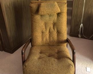 Item 16: Adrian Pearsall for Craft Associates Recliner $385 Highback cushioned recliner upholstered in nubby mustard fabric. Weighted strap headrest present. Reclining mechanism in good working order. Upholstery appears to be in good condition, but the entire chair needs a deep clean to get the dust out.