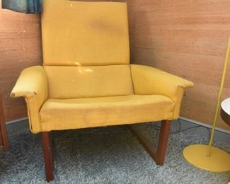 Item 17: Midcentury Lounge Chair & Foot Rest $425 Unmarked. Upholstered in yellow loose-weave fabric. The upholstery is soiled and has holes at wear points. Frame of both chair and foot rest are sound.