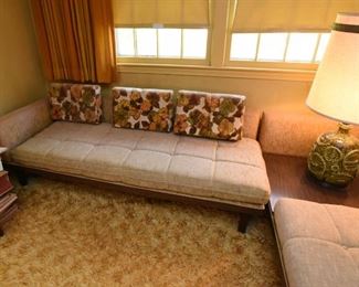 Item 24: Mid Century sectional $345 Platform Sectional sofa with an attached side table. Upholstery is in good condition, although there is a duct tape repair on one arm. Attached side table has a faux wood laminate surface. Frame is sturdy and in good condition.