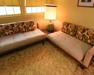Item 24: Mid Century sectional $345 Platform Sectional sofa with an attached side table. Upholstery is in good condition, although there is a duct tape repair on one arm. Attached side table has a faux wood laminate surface. Frame is sturdy and in good condition.