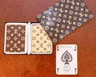Item 39: Vintage Louis Vuitton Playing Cards $125 1970s, Made in France by Heron. Logo box holds two decks of cards. One deck is brown, the other is cream. Both decks have all 52 cards, plus 2 jokers, and one with instructions. Cards have gilt edges. Paper has remained bright white. These are in exceptional condition.
