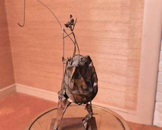 Item 43: Brutalist rock sculpture $45 Abastract wire and metal form around rock.