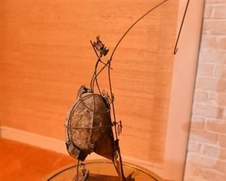 Item 43: Brutalist rock sculpture $45 Abastract wire and metal form around rock.