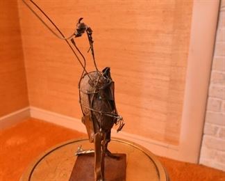 Item 43: Brutalist rock sculpture $45 Abastract wire and metal form around rock.