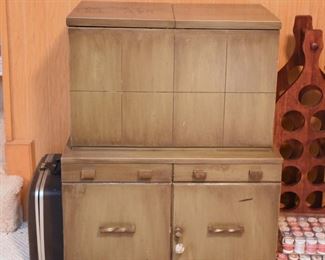 Item 46: Bar cabient $95 Weathered green midcentury brutalist bar cabinet has locking storage in the bottom. The top flips open to lift up a shelf with storage for differnt size drinkware. Even has small scale hydraulics to allow the shelf to sink back in gently and close softly. There's enough overall wear and damage from use that this will be a project.