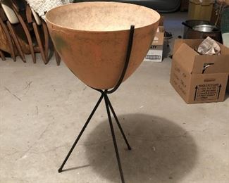Item 53: Mid Century Bullet Planter $75 The fiberglass pot has been painted orange and has green splotchy spray paint. Legs have some rust.