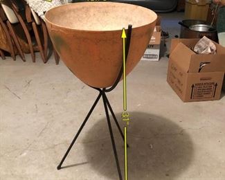 Item 53: Mid Century Bullet Planter $75 The fiberglass pot has been painted orange and has green splotchy spray paint. Legs have some rust.