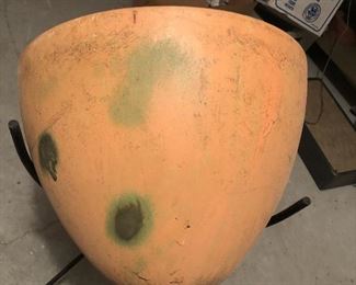 Item 53: Mid Century Bullet Planter $75 The fiberglass pot has been painted orange and has green splotchy spray paint. Legs have some rust.