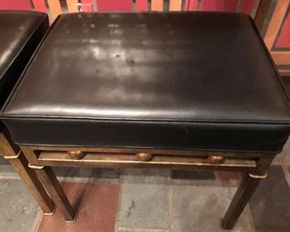 Item 55: Glass top metal table with two bench seats $165 Glass is free of chips or cracks. Seats are upholstered in black vinyl with piping. One stool has four impressions in the vinyl as shown. Good condition.