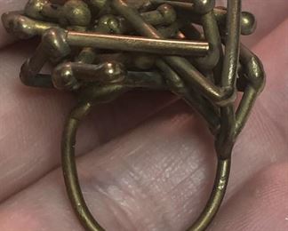 ITEM 86: Brass ring $22 Approximately size 7, this ring is comprised of a tangle of brass rods with bulbous ends.