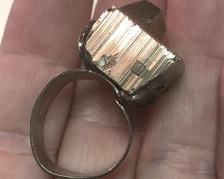 ITEM 85: Metal Chunk Ring $22 Open, flexible size sterling band, supports chunk of an unknown metal "crystal." Metal chunk is dark silver tone, but reflects some gold-tones under certain lights.