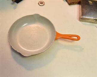 ITEM 98: Orange enameled cast iron 9" skillet $20 Unmarked, likely made in Belgium.