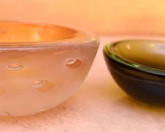 ITEM 120: Three Art Glass Bowls $55 L to R: Thick glass bowl with bubbles. The Interior has layers of orange glass and crackled gold encased in clear glass; green-brown shallow glass bowl; sea-green ribbed glass tri-form bowl.