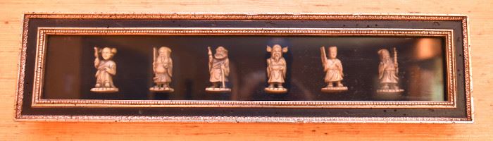 ITEM 121: Framed Netsuke $38 Six small figures encased in a shadow box.