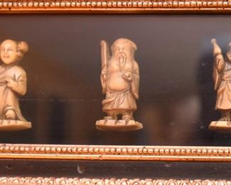 ITEM 121: Framed Netsuke $38 Six small figures encased in a shadow box.