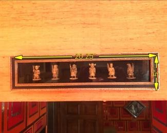 ITEM 121: Framed Netsuke $38 Six small figures encased in a shadow box.
