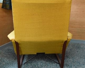 Item 17: Midcentury Lounge Chair & Foot Rest $425 Unmarked. Upholstered in yellow loose-weave fabric. The upholstery is soiled and has holes at wear points. Frame of both chair and foot rest are sound.