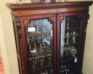 cabinets filled with Baccarat, Waterford, and Stueben