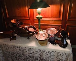 vintage metal lamp and a table filled with early wooden tureens and bowls