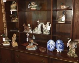 Midcentury modern china cabinet loaded with duck and bird figurines