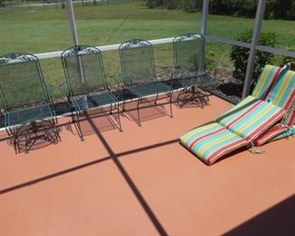 Lot of 4 dark green iron patio chairs w/colorful cushions - 2 swivel https://ctbids.com/#!/description/share/410445